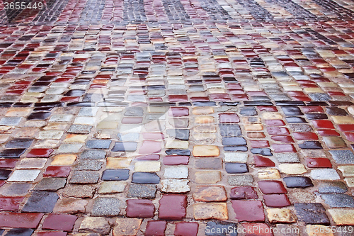 Image of Colour wet cobblestone road in rainy weather