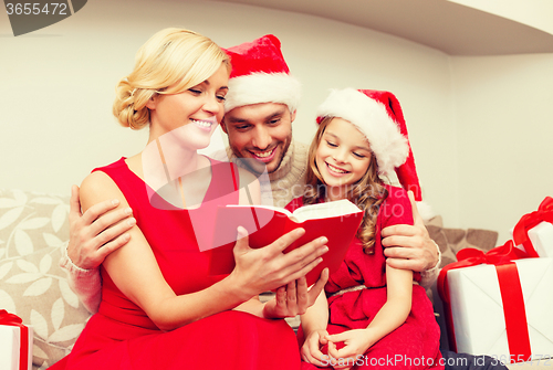 Image of smiling family reading book