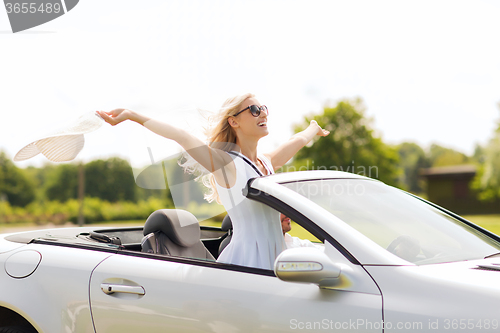 Image of happy man and woman driving in cabriolet car