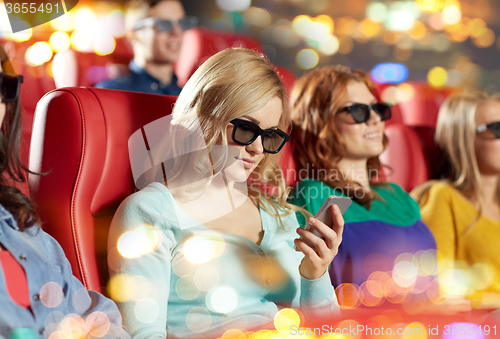 Image of happy woman with smartphone in 3d movie theater