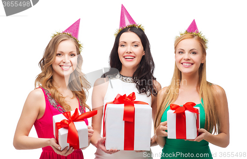 Image of three smiling women in blue hats with gift boxes