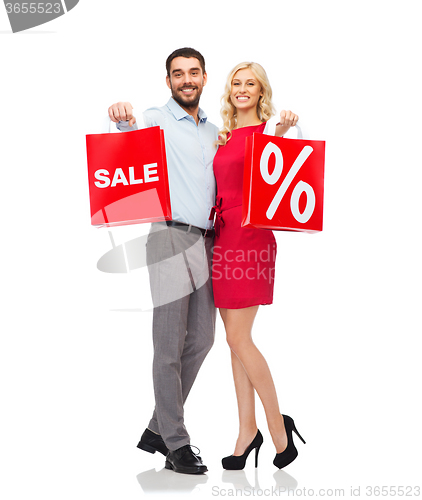 Image of happy couple with red shopping bags