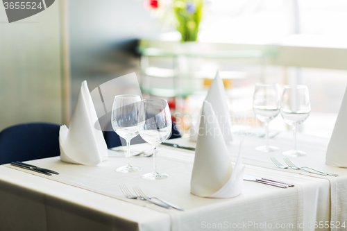 Image of close up of table setting with glasses and cutlery