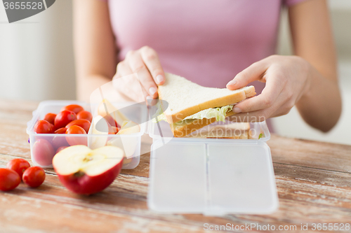 Image of close up of woman with food in plastic container