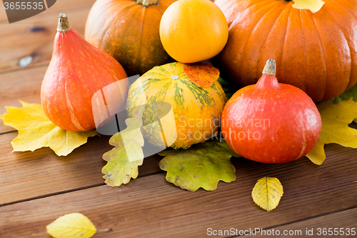 Image of close up of pumpkins on wooden table at home