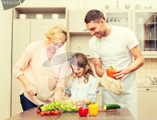 Image of happy family making dinner in kitchen