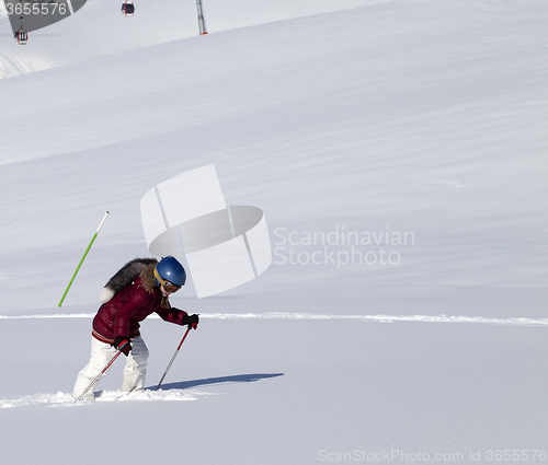 Image of Little skier on off-piste slope with new fallen snow at nice sun