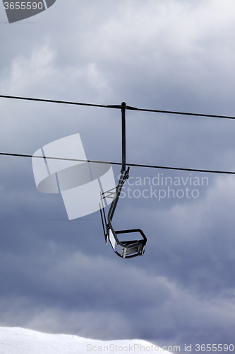 Image of Chair lift at gray windy day