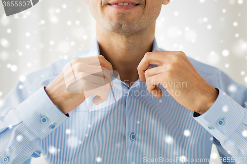 Image of close up of smiling man in shirt dressing