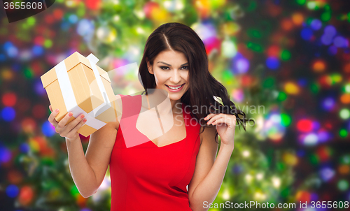 Image of beautiful sexy woman in red dress with gift box