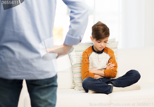 Image of upset or feeling guilty boy and father at home