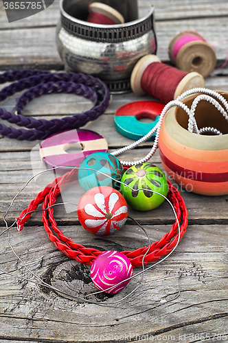 Image of beads on wooden background