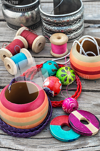 Image of beads on wooden background