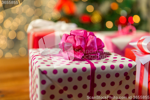 Image of close up of gift boxes over christmas tree lights
