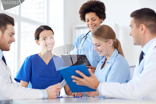 Image of group of happy doctors meeting at hospital office