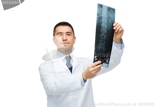 Image of male doctor in white coat holding x-ray