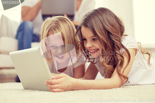 Image of happy little girls with tablet pc computer at home