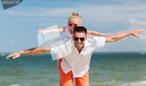 Image of happy family having fun on summer beach