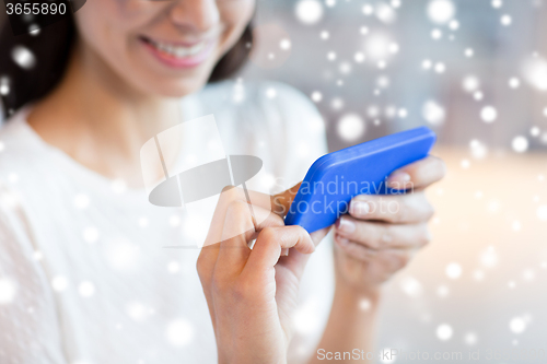 Image of close up of woman with smartphone at cafe