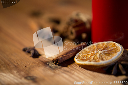 Image of cinnamon, anise and dried orange on wooden board