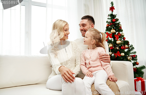 Image of happy family at home with christmas tree