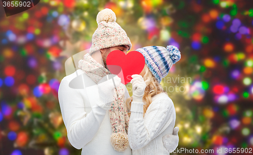 Image of smiling couple in winter clothes with red heart