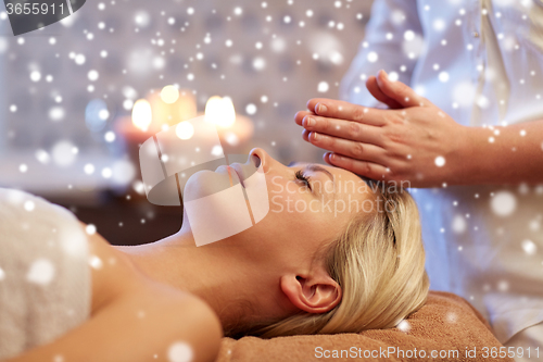 Image of close up of woman having face massage in spa salon