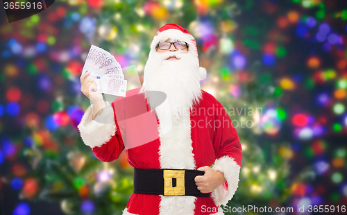 Image of man in costume of santa claus with euro money