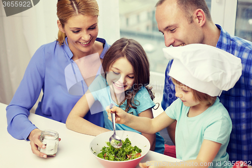 Image of happy family with two kids cooking at home