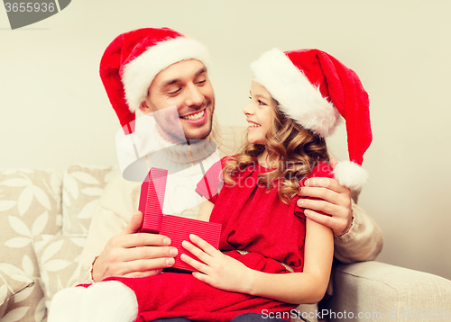 Image of smiling father and daughter opening gift box