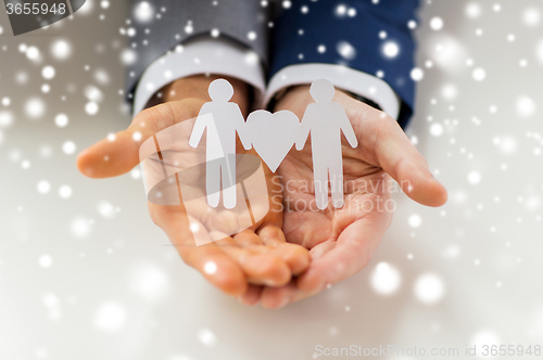 Image of close up of happy male gay couple with love symbol