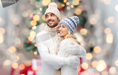 Image of smiling couple in winter clothes hugging