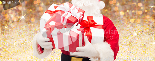 Image of man in costume of santa claus with gift boxes