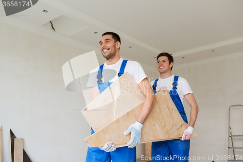 Image of group of builders with wooden boards