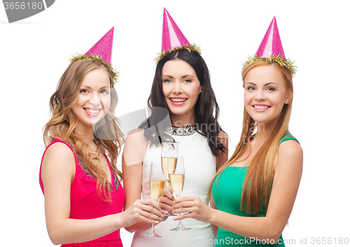 Image of three women in pink hats with champagne glasses