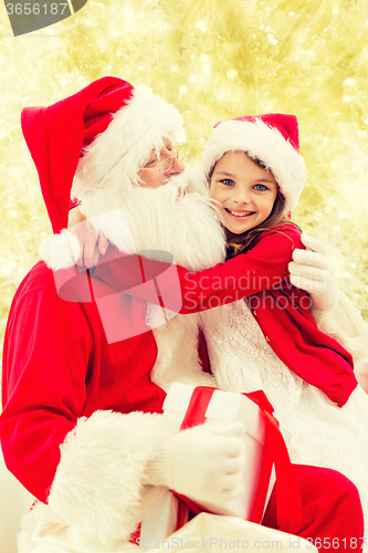 Image of smiling little girl with santa claus