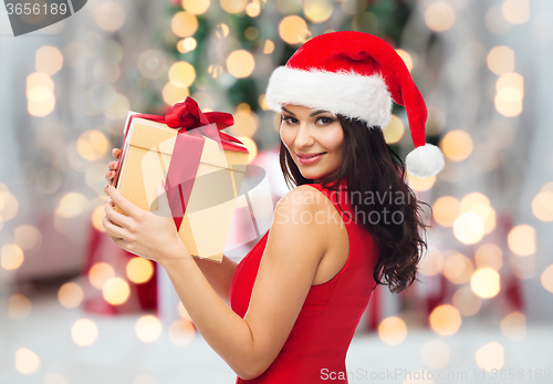 Image of beautiful sexy woman in santa hat with gift box