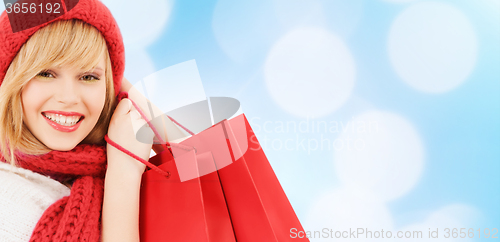 Image of smiling young woman with shopping bags