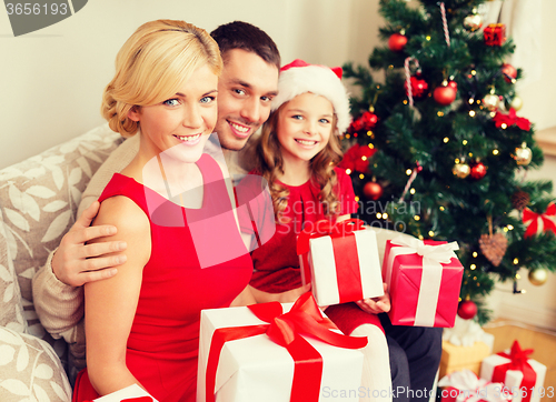 Image of smiling family holding many gift boxes