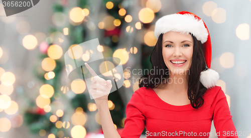 Image of smiling woman in santa helper hat