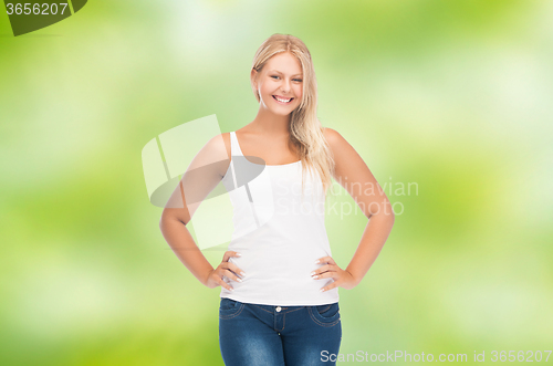 Image of smiling young woman in blank white shirt and jeans