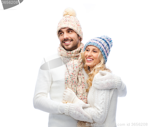 Image of smiling couple in winter clothes hugging