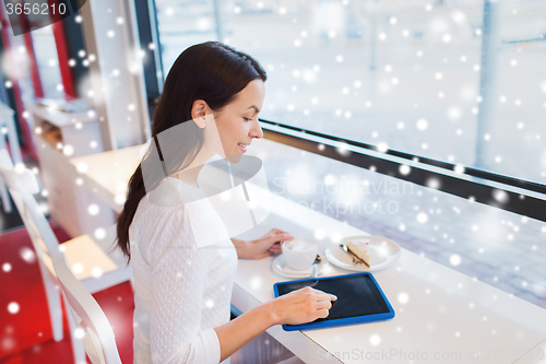 Image of smiling woman with tablet pc and coffee at cafe