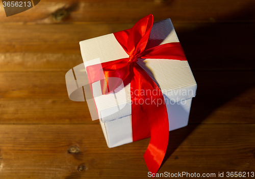 Image of close up of christmas  gift box on wooden floor