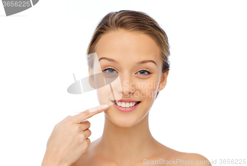 Image of smiling young woman face and shoulders