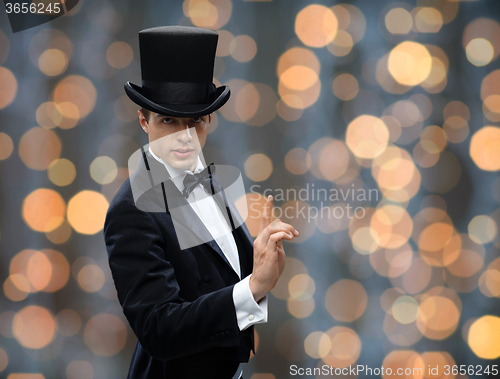 Image of magician in top hat pointing finger up