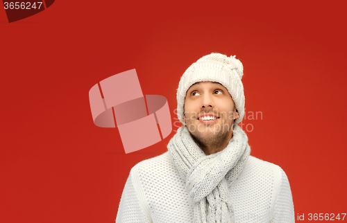 Image of handsome man in warm sweater, hat and scarf