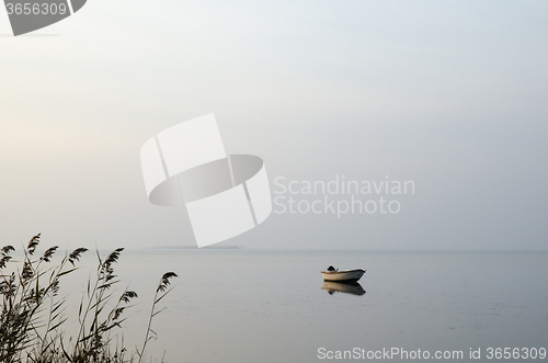 Image of Lone rowing boat in calm water