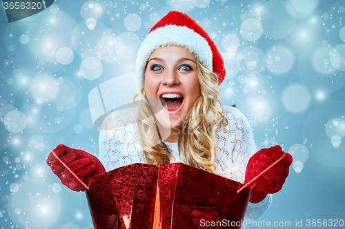 Image of Beautiful young woman in Santa Claus clothes