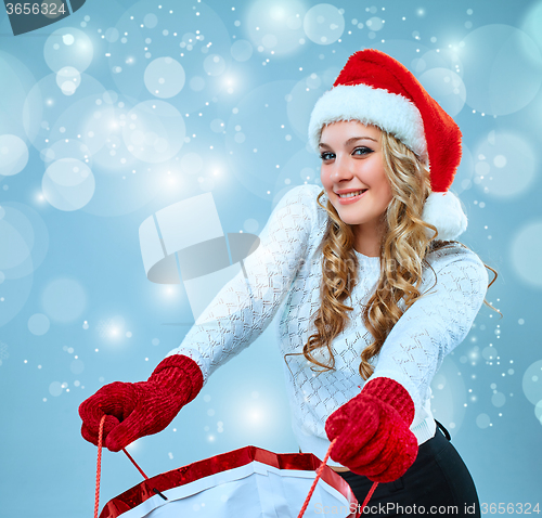 Image of Beautiful young woman in Santa Claus clothes